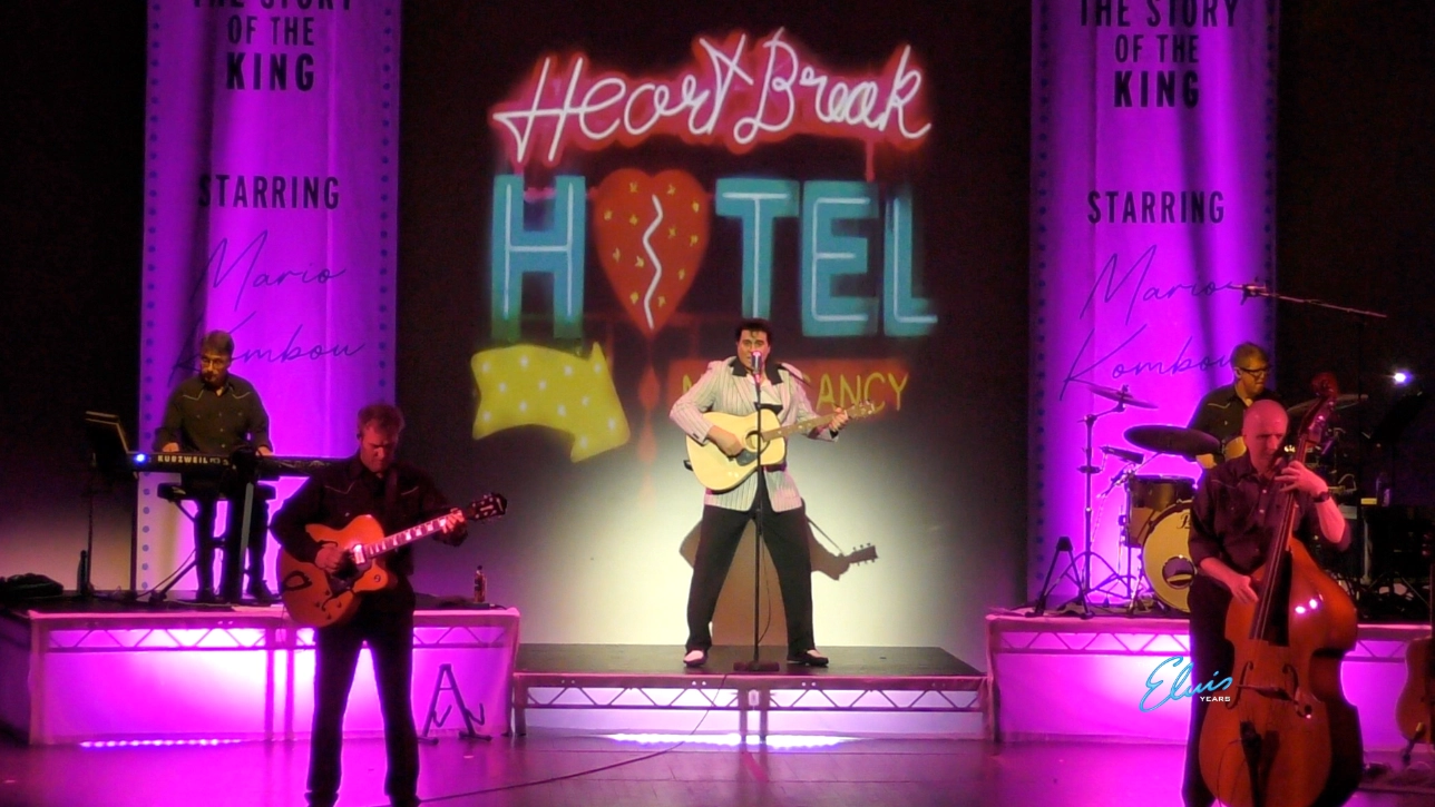 Mario Kombou from the Elvis Years on stage with guitar performing Heartbreak Hotel 