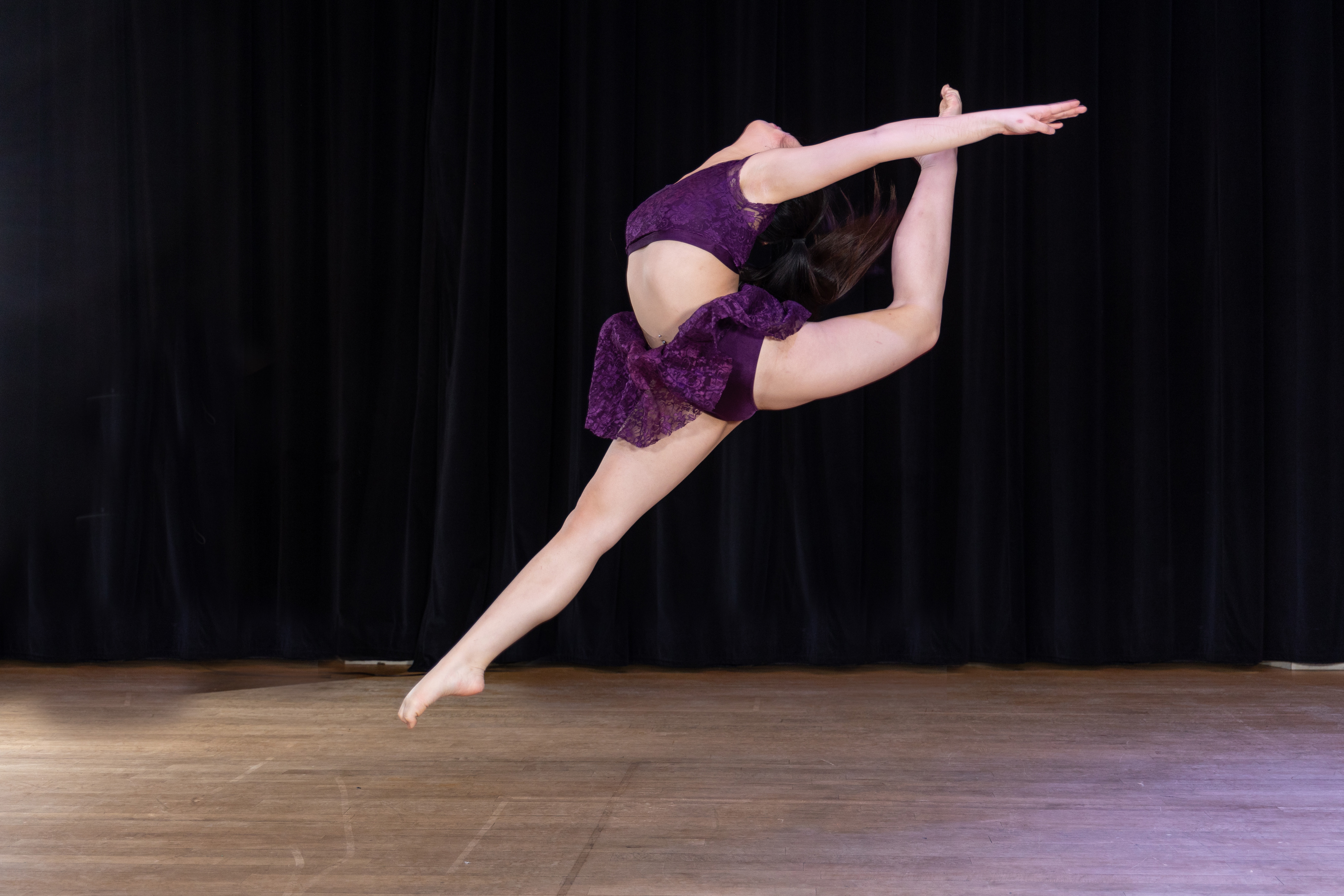 HI Dancer in mid air dance move in two piece purple outfit